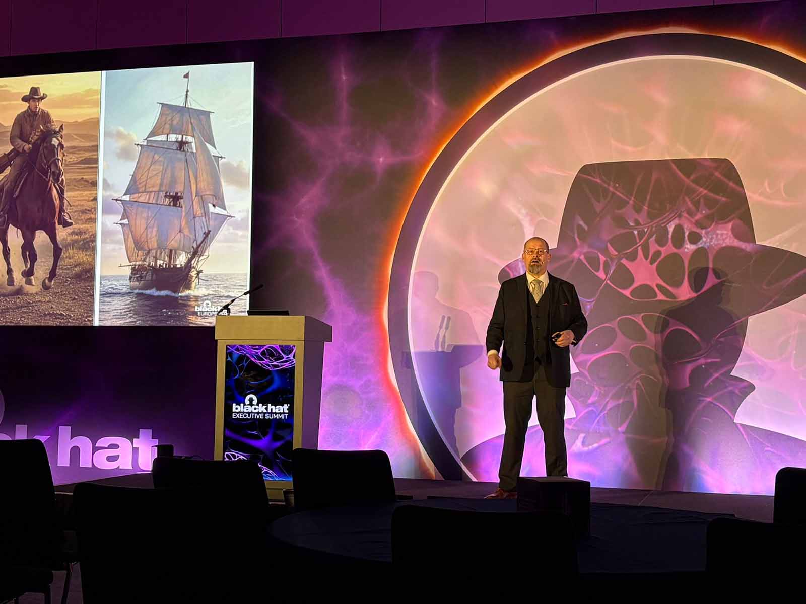 Kai presenting on stage at Black Hat Executive Summit